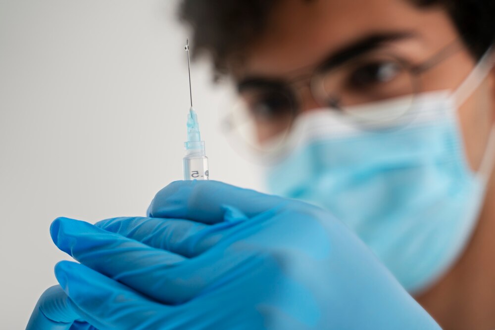 Side view blurry doctor holding injection