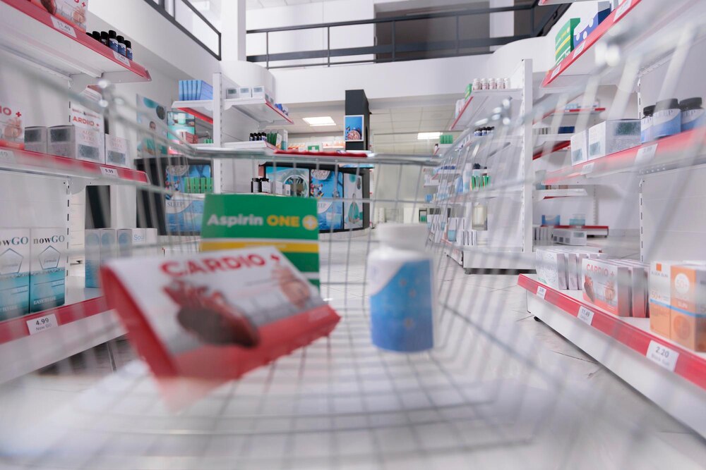 Store basket filled with pharmaceutics and pills ready to be buy by clients during checkup visit in drugstore. Pharmacy also carried a variety of other medical products, bandages and cold medicine.