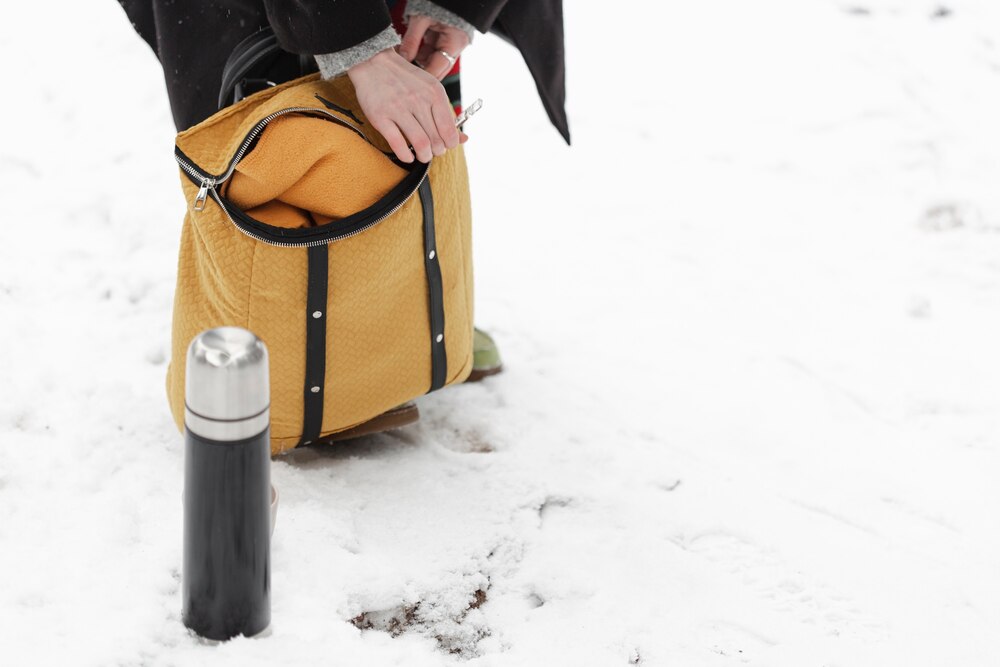 Winter landscape and coffee in thermos